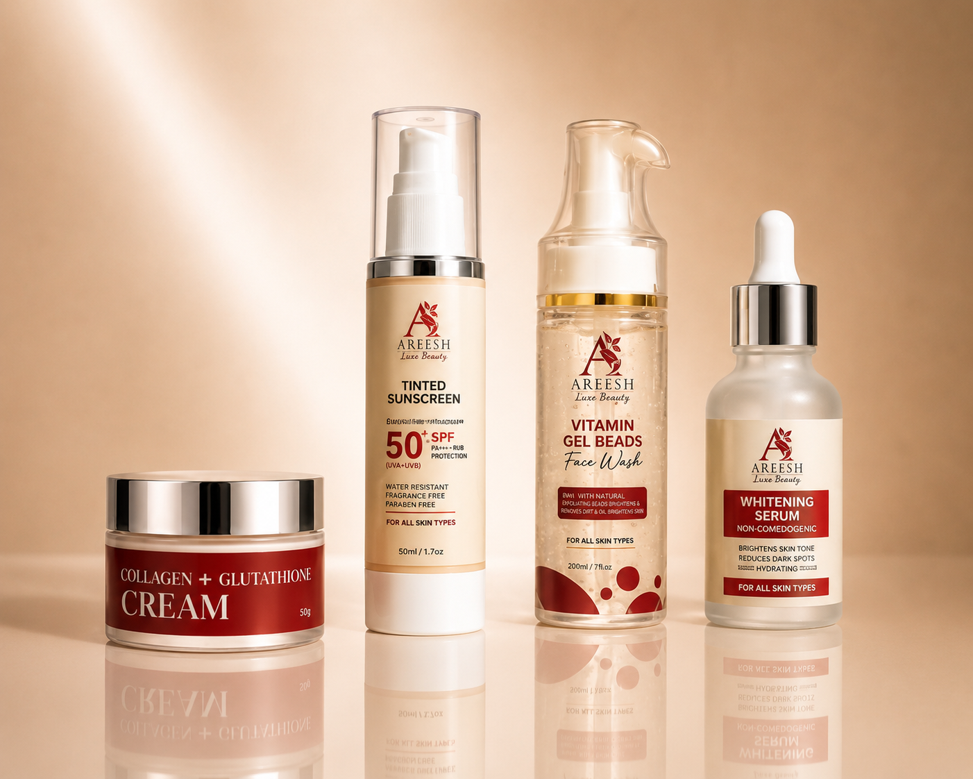 Four skincare products from Alesha Beauty arranged on a reflective beige surface against a warm beige background: a Collagen + Glutamine Cream jar, a Tinted Sunscreen bottle, a Vitamin Gel Beads Face Wash bottle, and a Whitening Serum dropper bottle.