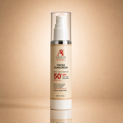 A 50ml bottle of Aareesh Brand Tinted Sunscreen SPF 50+ on a warm beige gradient background with a soft reflection below.